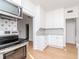 Kitchen featuring stainless steel appliances, black-and-white backsplash, and hardwood flooring at 5807 N Miami Pl, Tampa, FL 33604