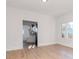 Bright living room featuring hardwood floors, white walls and doorways leading to kitchen at 5807 N Miami Pl, Tampa, FL 33604