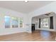 Bright living room featuring hardwood floors, a fireplace and built in bookshelves and large windows at 5807 N Miami Pl, Tampa, FL 33604