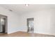 Bright living room featuring hardwood floors, white walls and doorways leading to other rooms at 5807 N Miami Pl, Tampa, FL 33604