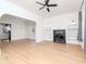 Inviting living room boasting light wood floors, a decorative fireplace, and a ceiling fan at 5807 N Miami Pl, Tampa, FL 33604