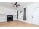 Bright living room featuring a decorative fireplace, built-in shelves, and an arched window at 5807 N Miami Pl, Tampa, FL 33604