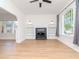 Bright living room with a black fireplace, hardwood floor and arched doorway to adjacent room at 5807 N Miami Pl, Tampa, FL 33604