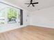 Open living room with ample natural light, modern light fixture, and an arched window at 5807 N Miami Pl, Tampa, FL 33604