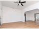 Spacious living room with modern light fixture, hardwood floors, and an arched doorway at 5807 N Miami Pl, Tampa, FL 33604