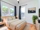 Well-lit main bedroom with hardwood floors, modern decor, and ample natural light for a relaxing ambiance at 5807 N Miami Pl, Tampa, FL 33604
