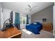 Bright bedroom featuring a blue bed, wood accent wall and natural lighting at 592 Black Lion Ne Dr, St Petersburg, FL 33716