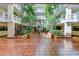 Interior view of a stunning courtyard with lush greenery and multi-story architecture at 6600 Sunset Way # 112, St Pete Beach, FL 33706