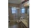 Bathroom features shower-tub combination and neutral vanity at 6704 Hickorywood Ln # 2B, New Port Richey, FL 34653