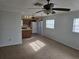 Bright living area with ceiling fan and neutral carpeting, showcasing an efficient layout and natural light at 6704 Hickorywood Ln # 2B, New Port Richey, FL 34653