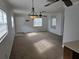 Open living room features neutral walls, neutral carpeting, and lots of natural light at 6704 Hickorywood Ln # 2B, New Port Richey, FL 34653