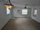 Inviting living room with ceiling fans and ample natural light from windows on two walls at 6704 Hickorywood Ln # 2B, New Port Richey, FL 34653