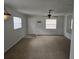 Open living room features neutral walls, neutral carpeting, and lots of natural light at 6704 Hickorywood Ln # 2B, New Port Richey, FL 34653