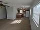 Sunlit living area with plush carpeting and seamless transition into a bright kitchen with modern appliances at 6704 Hickorywood Ln # 2B, New Port Richey, FL 34653