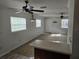 Cozy living room with carpeted floors, ceiling fan, and views into the kitchen area at 6704 Hickorywood Ln # 2B, New Port Richey, FL 34653