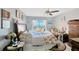 Cozy bedroom featuring a floral bedspread, ceiling fan, and bright natural light with water views at 7432 Sunshine Skyway S Ln # 502, St Petersburg, FL 33711