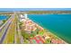 Expansive aerial view showcasing the waterfront property with bay views, lush landscaping and tennis courts at 7432 Sunshine Skyway S Ln # 602, St Petersburg, FL 33711