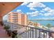 Balcony view of a condo building, featuring ocean views, landscaping, and ample parking at 7432 Sunshine Skyway S Ln # 602, St Petersburg, FL 33711