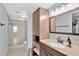 Well-lit bathroom features a glass-enclosed shower, tile flooring, and updated vanity at 7432 Sunshine Skyway S Ln # 602, St Petersburg, FL 33711