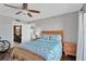 Serene bedroom with wood trim, showcasing a charming quilt and view to ensuite bathroom at 7432 Sunshine Skyway S Ln # 602, St Petersburg, FL 33711