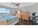 Bright bedroom featuring water views from a sliding glass door, complemented by warm wooden furniture at 7432 Sunshine Skyway S Ln # 602, St Petersburg, FL 33711