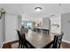 Spacious dining room with a large wooden table set for six, blending into a view of living areas at 7432 Sunshine Skyway S Ln # 602, St Petersburg, FL 33711