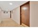 Hallway leading to unit door with lockbox, unit number, and neutral walls and carpeting at 7432 Sunshine Skyway S Ln # 602, St Petersburg, FL 33711