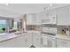 Updated kitchen featuring modern appliances, white cabinets, and a water view at 7432 Sunshine Skyway S Ln # 602, St Petersburg, FL 33711
