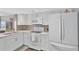 Modern kitchen with updated appliances, tile backsplash, and lots of cabinet space at 7432 Sunshine Skyway S Ln # 602, St Petersburg, FL 33711