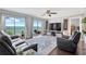 Bright living room with water views and balcony access at 7432 Sunshine Skyway S Ln # 602, St Petersburg, FL 33711