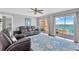 Spacious living room featuring a ceiling fan, water views, and sliders leading to a balcony at 7432 Sunshine Skyway S Ln # 602, St Petersburg, FL 33711