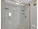 Modern walk-in shower with updated hardware, white subway tiling, and convenient shelving at 7432 Sunshine Skyway S Ln # 602, St Petersburg, FL 33711