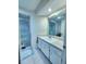Well-lit bathroom with glass-enclosed shower and white vanity with storage at 7530 Roy Ct, New Port Richey, FL 34654