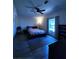 Comfortable bedroom with modern platform bed, ceiling fan, and large window at 7530 Roy Ct, New Port Richey, FL 34654