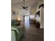 Spacious living room featuring vaulted ceilings, modern ceiling fan, and wood-look tile flooring at 7530 Roy Ct, New Port Richey, FL 34654