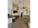 Open floor plan with kitchen breakfast bar, TV, vaulted ceilings and a modern ceiling fan at 7530 Roy Ct, New Port Richey, FL 34654