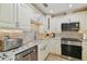 Close up of kitchen details with stainless appliances and granite counters at 7615 W Osborne Ave, Tampa, FL 33615