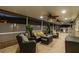 Screened-in patio seating area adjacent to the pool with ceiling fans and neutral furnishings at 7615 W Osborne Ave, Tampa, FL 33615