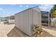 Outdoor shed with brick paving, adjacent to a screened-in lanai for convenient storage and leisure at 7615 W Osborne Ave, Tampa, FL 33615