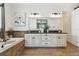 Elegant bathroom with a soaking tub, tile accents, and a large vanity with double sinks at 8307 Bluevine Sky Dr, Land O Lakes, FL 34637