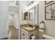 Powder room featuring vanity, tiled floors, and neutral paint at 8307 Bluevine Sky Dr, Land O Lakes, FL 34637