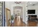 Grand foyer featuring hardwood floors, elegant archways, and a clear view into the open living space at 8307 Bluevine Sky Dr, Land O Lakes, FL 34637