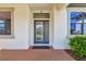 Elegant front door with decorative glass and sidelights, set in a bright and welcoming entrance at 8307 Bluevine Sky Dr, Land O Lakes, FL 34637