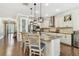 Well-equipped kitchen featuring granite countertops, stainless steel appliances, a pantry door, and an open design at 8307 Bluevine Sky Dr, Land O Lakes, FL 34637