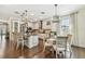Spacious kitchen with granite counters, stainless appliances, and a kitchen island, flowing into the dining area and living room at 8307 Bluevine Sky Dr, Land O Lakes, FL 34637
