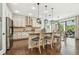 Beautiful kitchen with granite countertops, stainless steel appliances, an island with bar seating, and an open layout at 8307 Bluevine Sky Dr, Land O Lakes, FL 34637