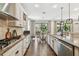 Well-lit kitchen featuring stainless steel appliances, granite countertops, and hardwood flooring at 8307 Bluevine Sky Dr, Land O Lakes, FL 34637
