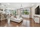 Spacious living room with contemporary furnishings, large windows, and hardwood floors at 8307 Bluevine Sky Dr, Land O Lakes, FL 34637