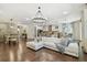 Open-concept living space with a gourmet kitchen, dining area, and luxurious seating at 8307 Bluevine Sky Dr, Land O Lakes, FL 34637