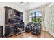 This home office features a stylish workstation and massage chairs for added comfort at 8307 Bluevine Sky Dr, Land O Lakes, FL 34637